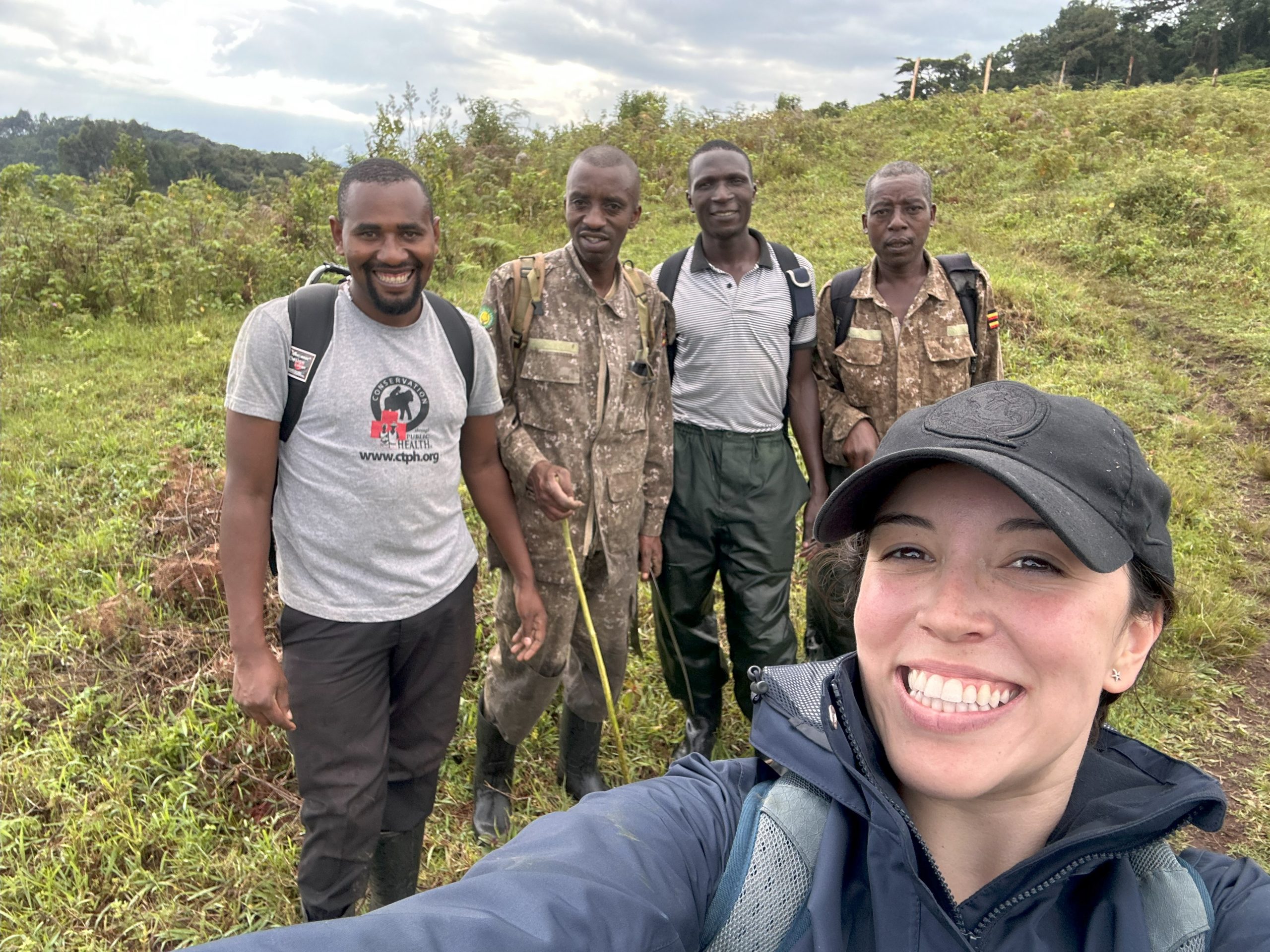 Carolina Baquerizo, DVM '24, in the field with Conservation Through Public Health laboratory technician Annaclet Ampeire and Uganda Wildlife Authority rangers.